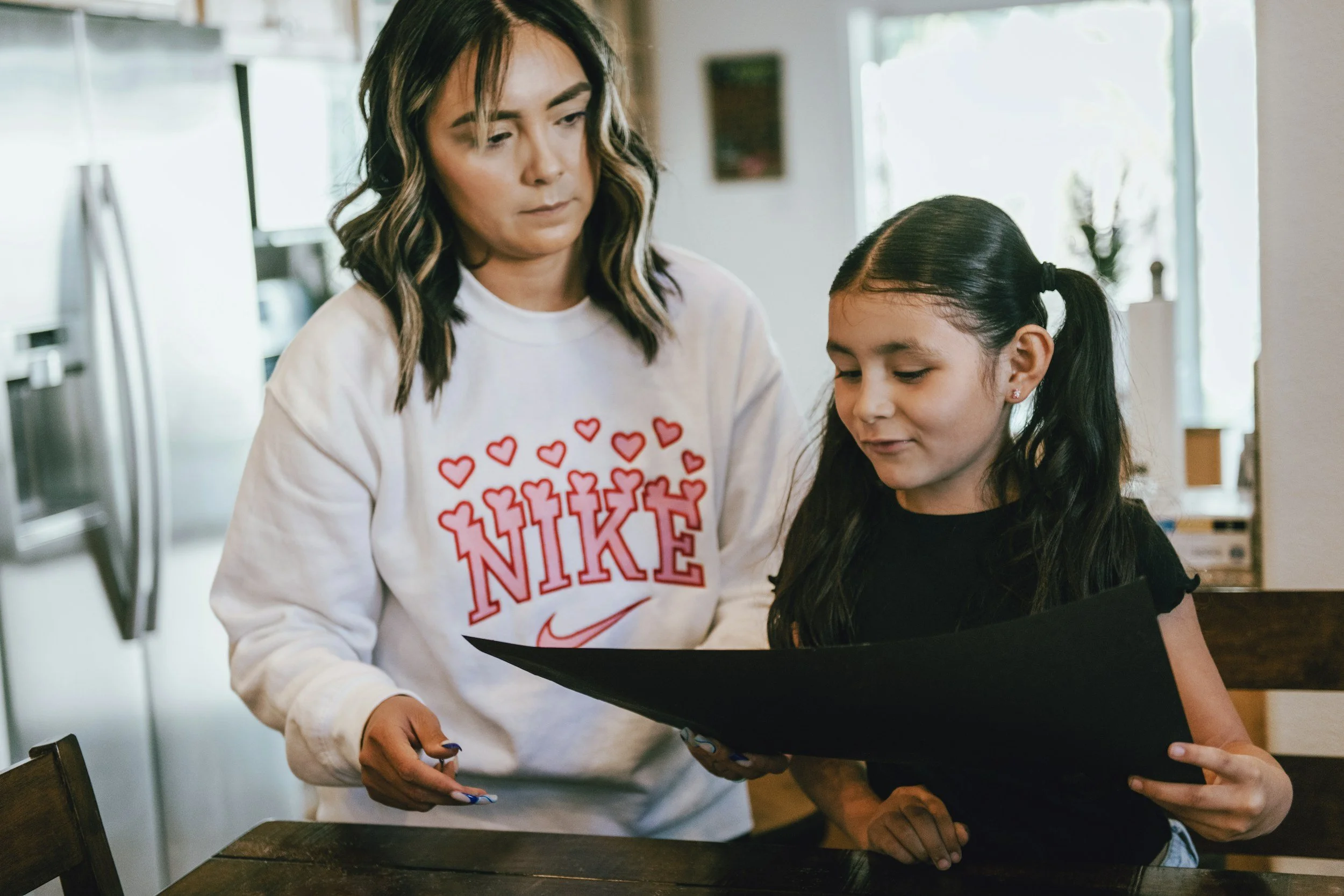 Parent and young person reviewing school work together